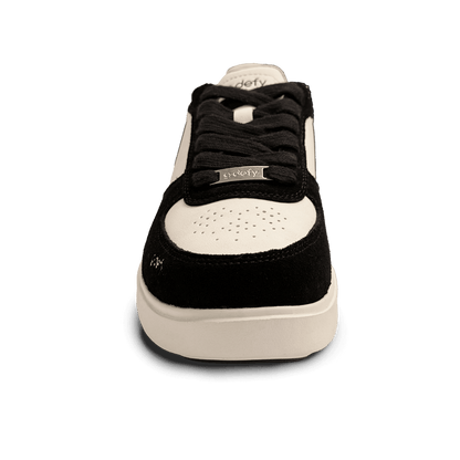 Black and white low-top sneaker with black laces and a silver 'g-defy' tag, featuring a perforated toe box.