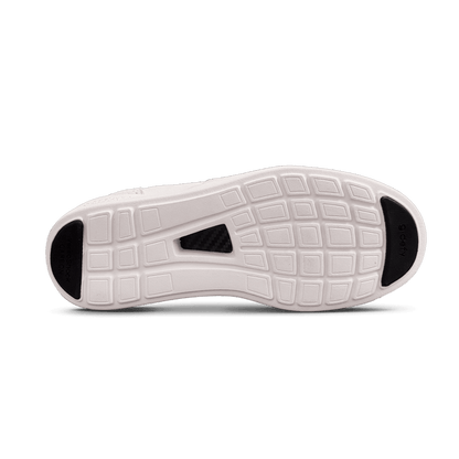Bottom of a white shoe sole with a grid pattern, black VersaShock Carbon toe, g-defy heel, and carbon fiber mid-sole.