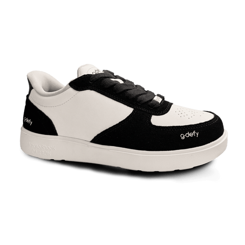 Black and white G-Defy sneaker, featuring a white leather upper, black suede overlays, black laces, and a thick white sole.